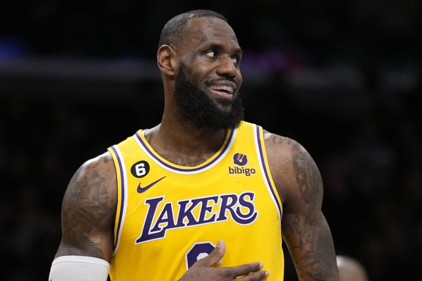 Los Angeles Lakers forward LeBron James smiles during the second half of an NBA basketball game.