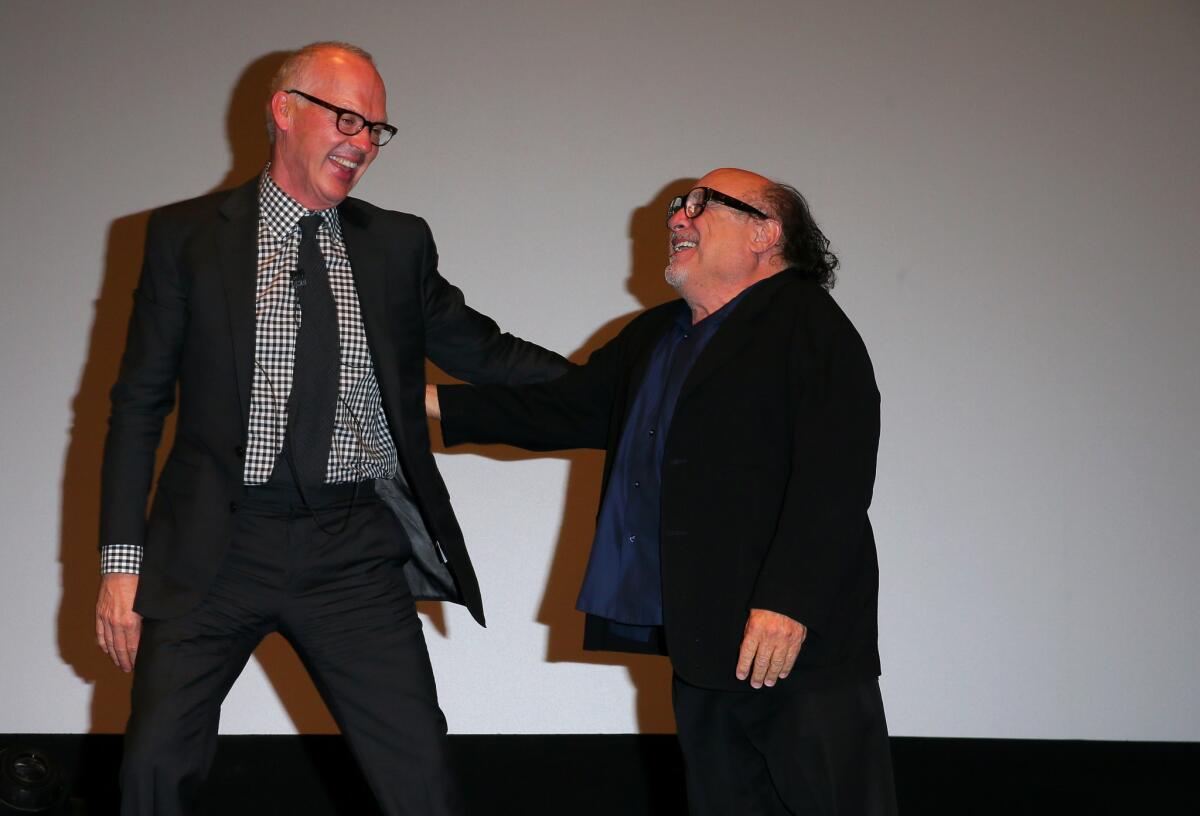 Michael Keaton, left, greets Danny DeVito during a special tribute to Keaton at the Santa Barbara International Film Festival on Saturday night.