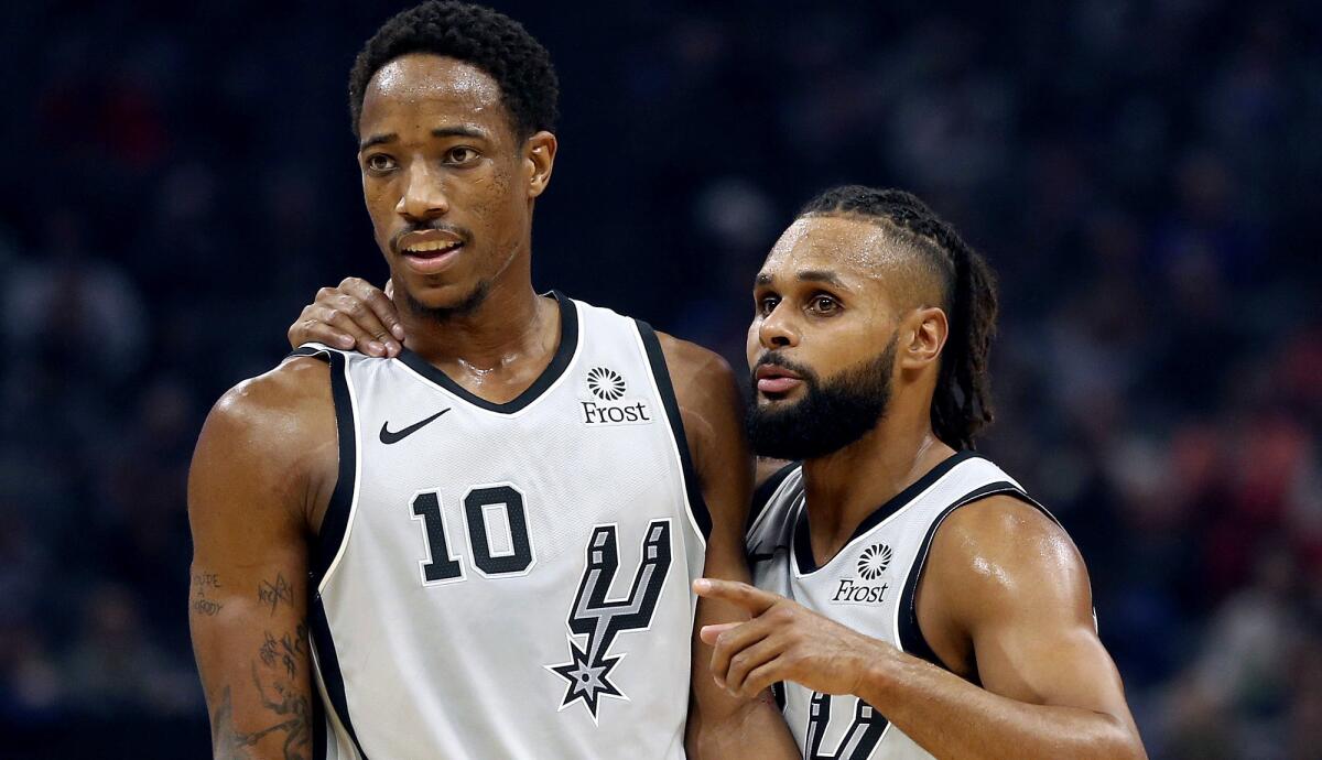 DeMar DeRozan (10) has been embraced by Patty Mills and the Spurs.