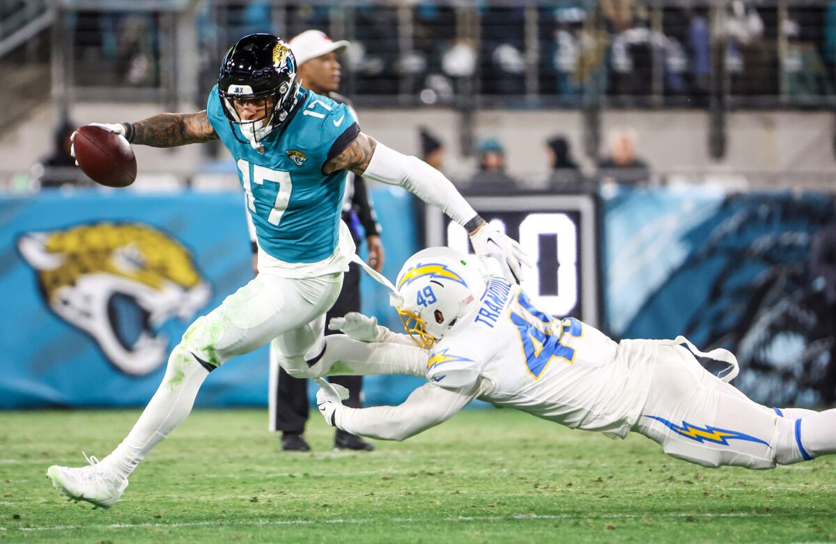 Chargers linebacker Drue Tranquill can't tackle Jaguars tight end Evan Engram.