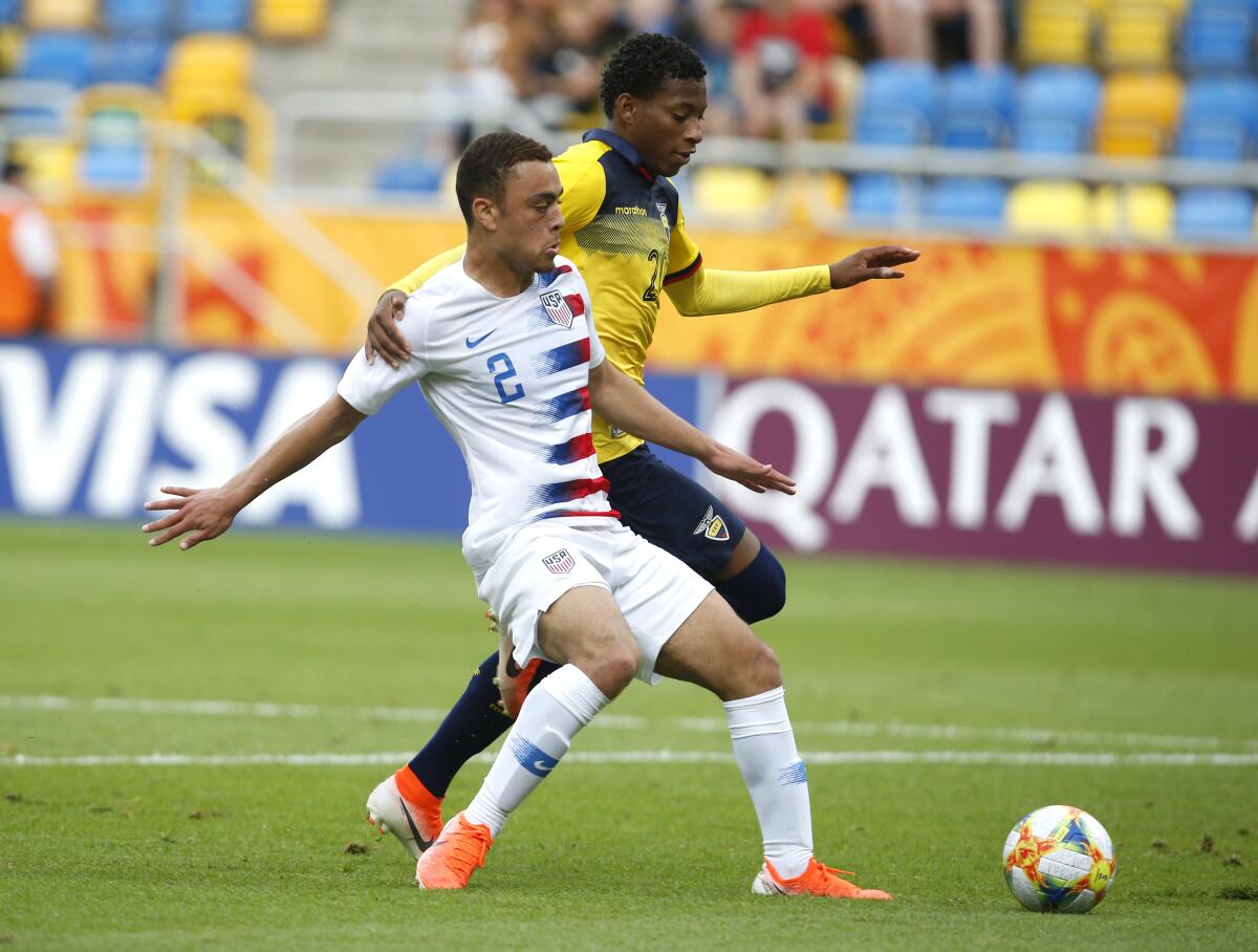 FILE - In this June 8, 2019, file photo, United States' Sergino Dest, left, and Ecuador's Gonzalo Plata challenge for the ball during a quarterfinal soccer match at the U20 World Cup in Gdynia, Poland. Sergiño Dest is set to become the first American to play for AC Milan in Serie A after the Italian champion signed the defender on loan from Barcelona on Thursday, Sept. 1, 2022, shortly before the transfer window shut. (AP Photo/Darko Vojinovic, File)