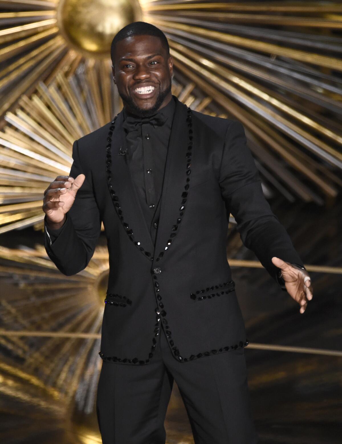 Kevin Hart presents The Weeknd at the 88th Academy Awards ceremony.