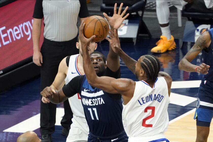 Minnesota Timberwolves' Naz Reid (11) tries to block a shot by Los Angeles Clippers' Kawhi Leonard (2) during the first half of an NBA basketball game, Wednesday, Feb. 10, 2021, in Minneapolis. (AP Photo/Jim Mone)