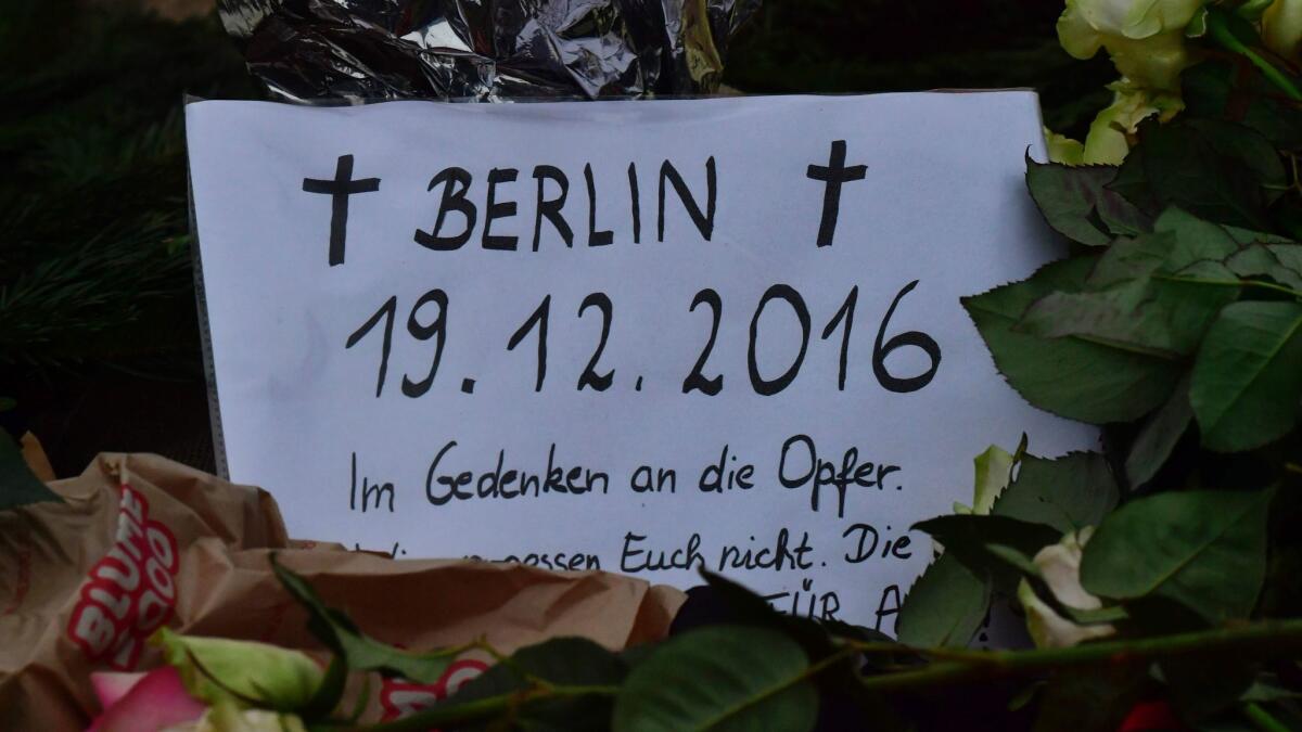 A card reading "In memory of the victims" is seen Dec. 20 at the site where a truck crashed into a Christmas market in Berlin.