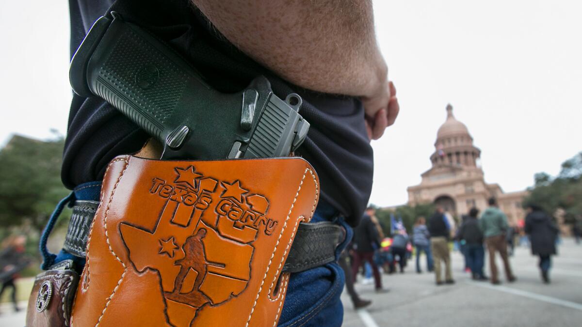 Terry Holcomb, executive director of Texas Carry, wears his customized holster at the state Capitol during a protest on Jan. 1.