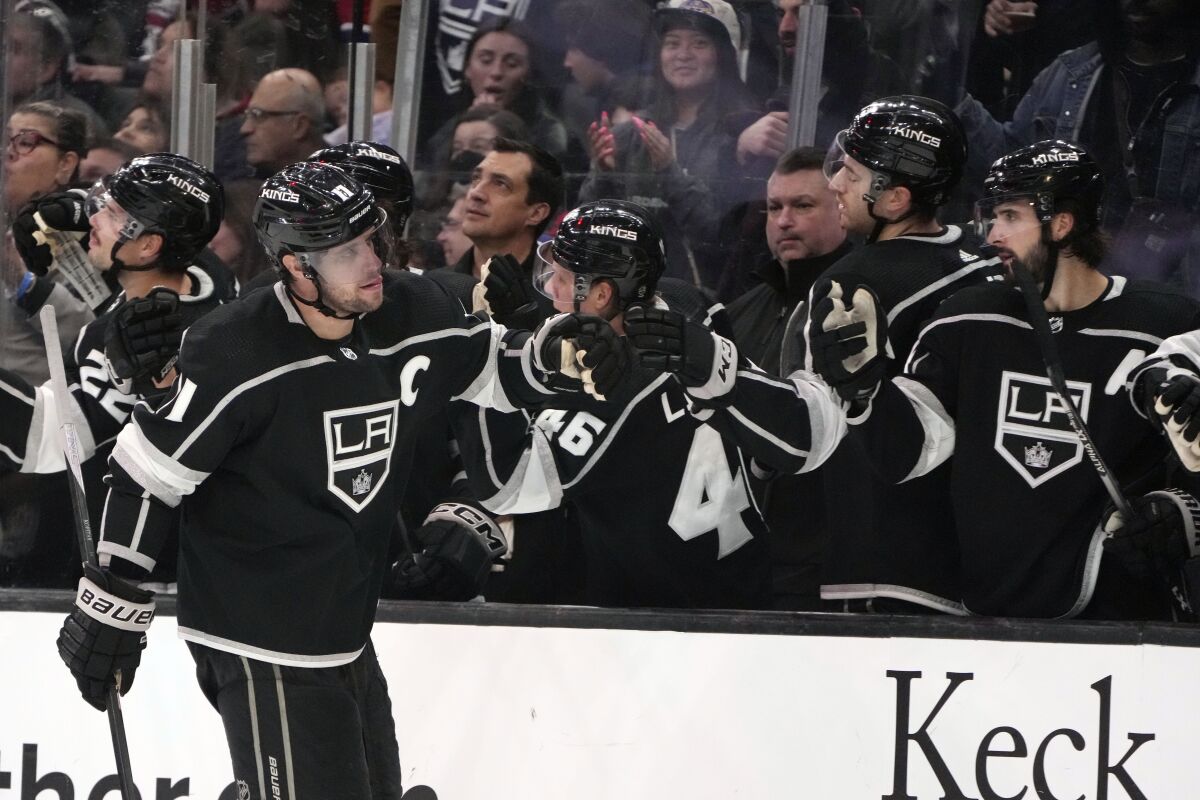 Kings captain Anze Kopitar, left, celebrates with teammates after scoring in the third period.