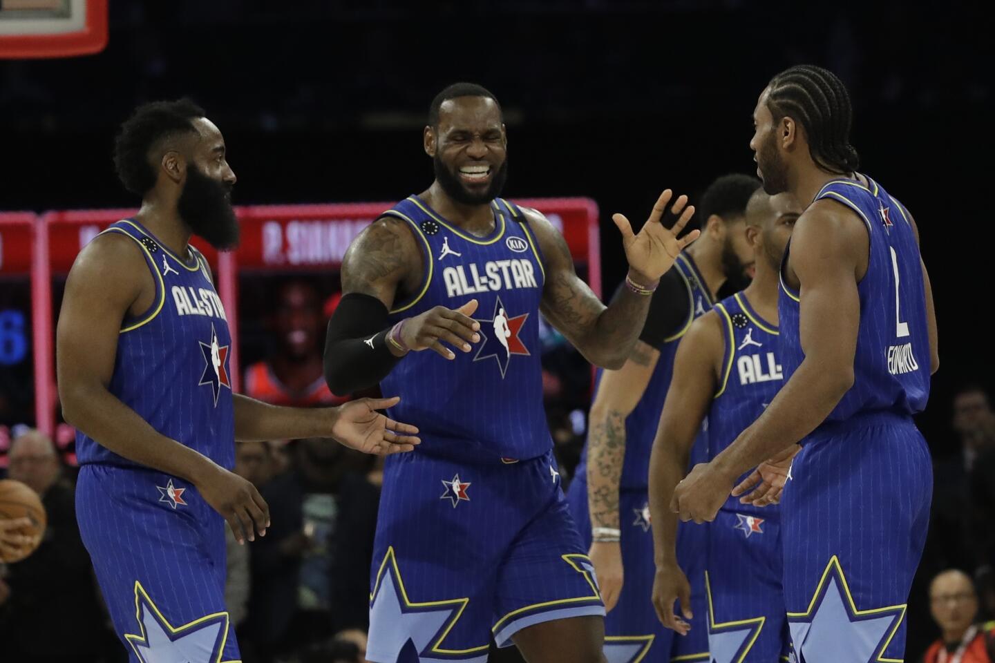 Lakers forward LeBron James, center, celebrates with teammates James Harden of Houston and Kawhi Leonard of the Clippers during the 69th NBA All-Star game at the United Center in Chicago on Feb. 16, 2020.