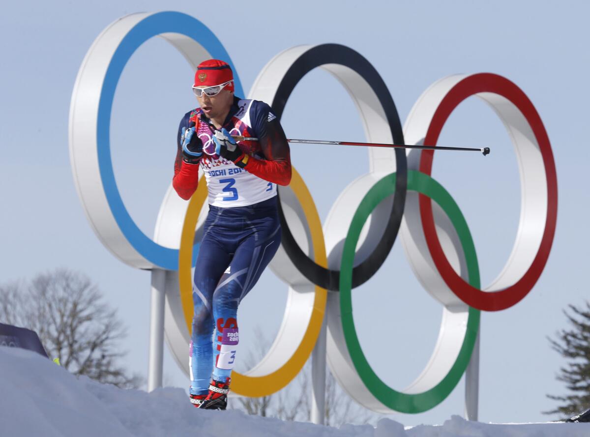 FILE - In this Feb. 23, 2014 file photo Russia's gold medal winner Alexander Legkov skis past the Olympic rings during the men's 50K cross-country race at the 2014 Winter Olympics in Krasnaya Polyana, Russia. The Court of Arbitration for Sport ruled on Thursday, Feb. 1, 2018 to reinstate Leskov as gold medal winner of the men's 50-kilometer cross-country skiing which he was stripped of on doping allegations earlier.