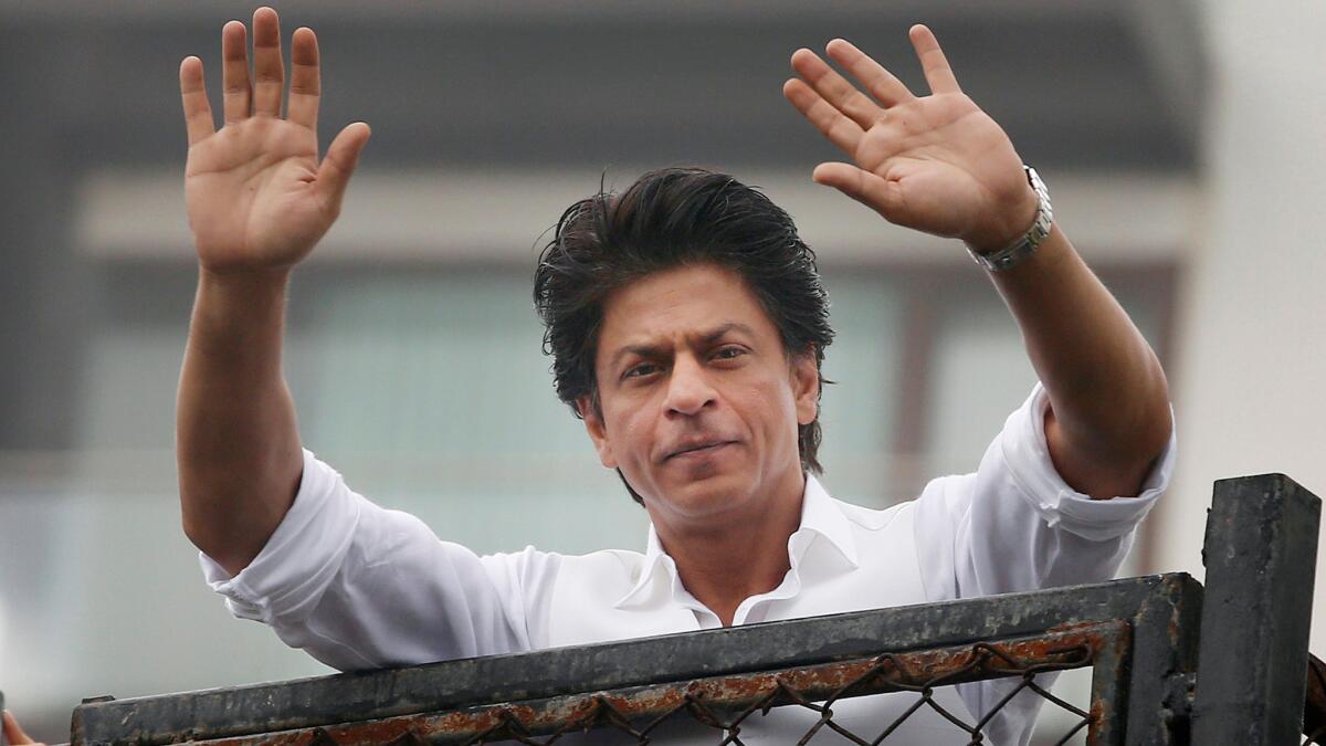 Bollywood actor Shah Rukh Khan greets fans waiting outside his residence in Mumbai, India, earlier this year.