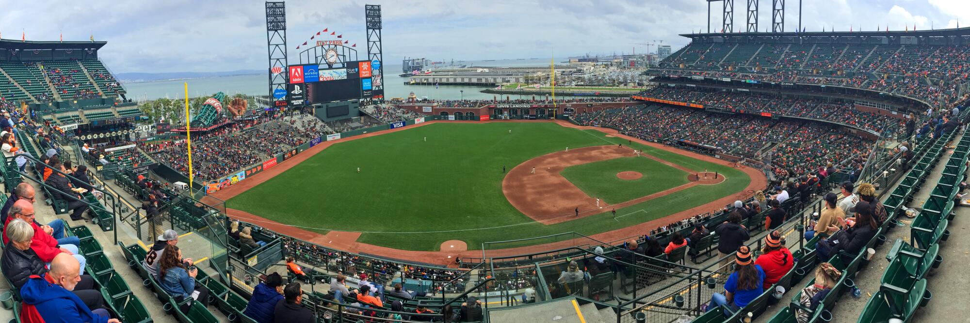 AT&T Park, San Francisco, with a view from the stands among attendees looking down on the baseball field and nearby bay.