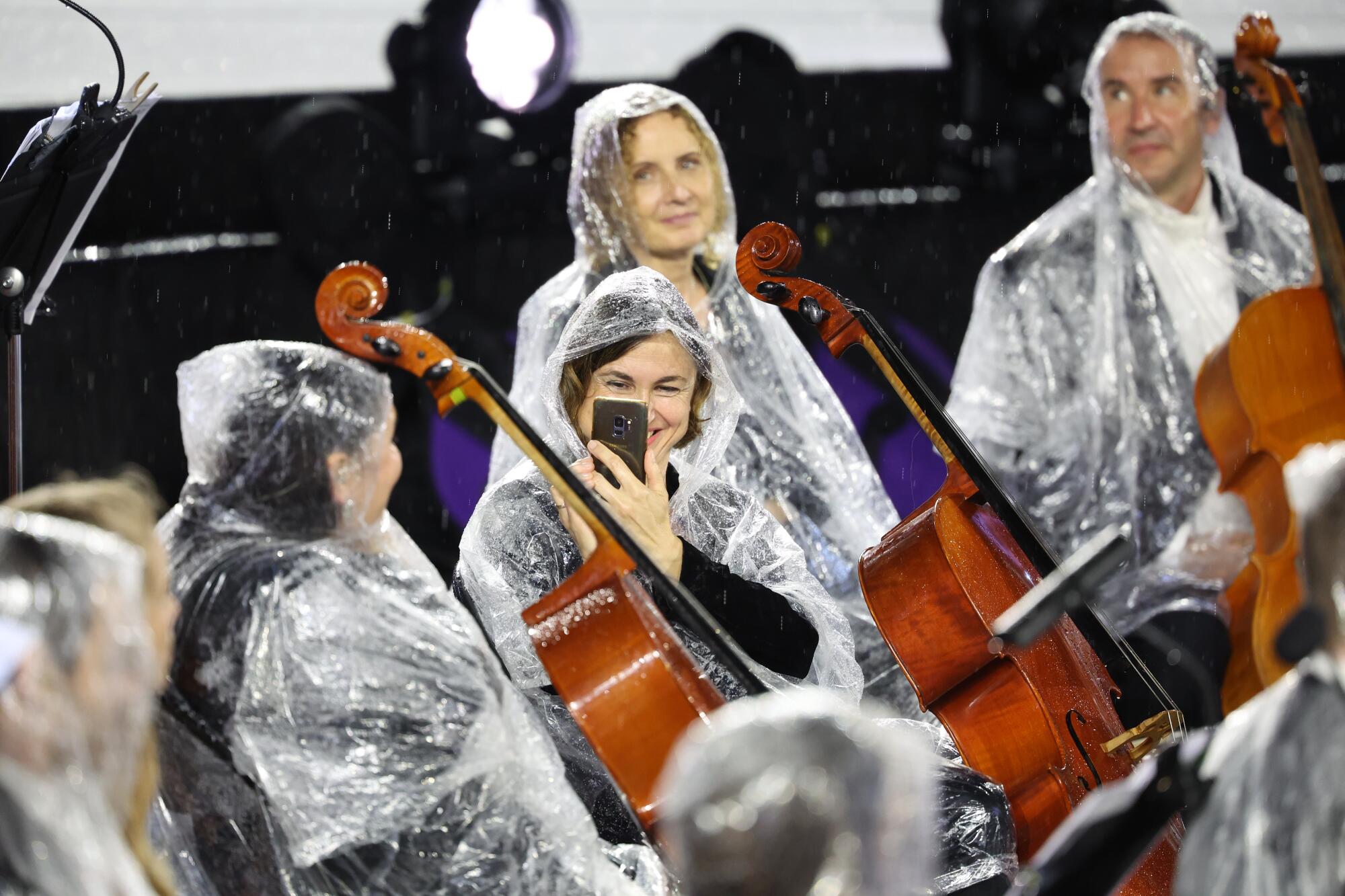 A musician takes a photo during the opening ceremony of the 2024 Summer Olympics in Paris.