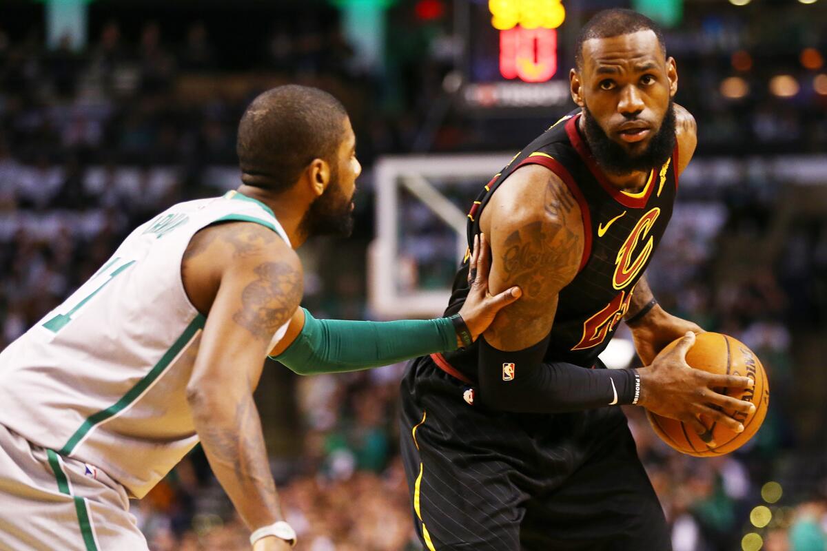 LeBron James is guarded by former Cavaliers teammate Kyrie Irving during a game against the Celtics at TD Garden last week.