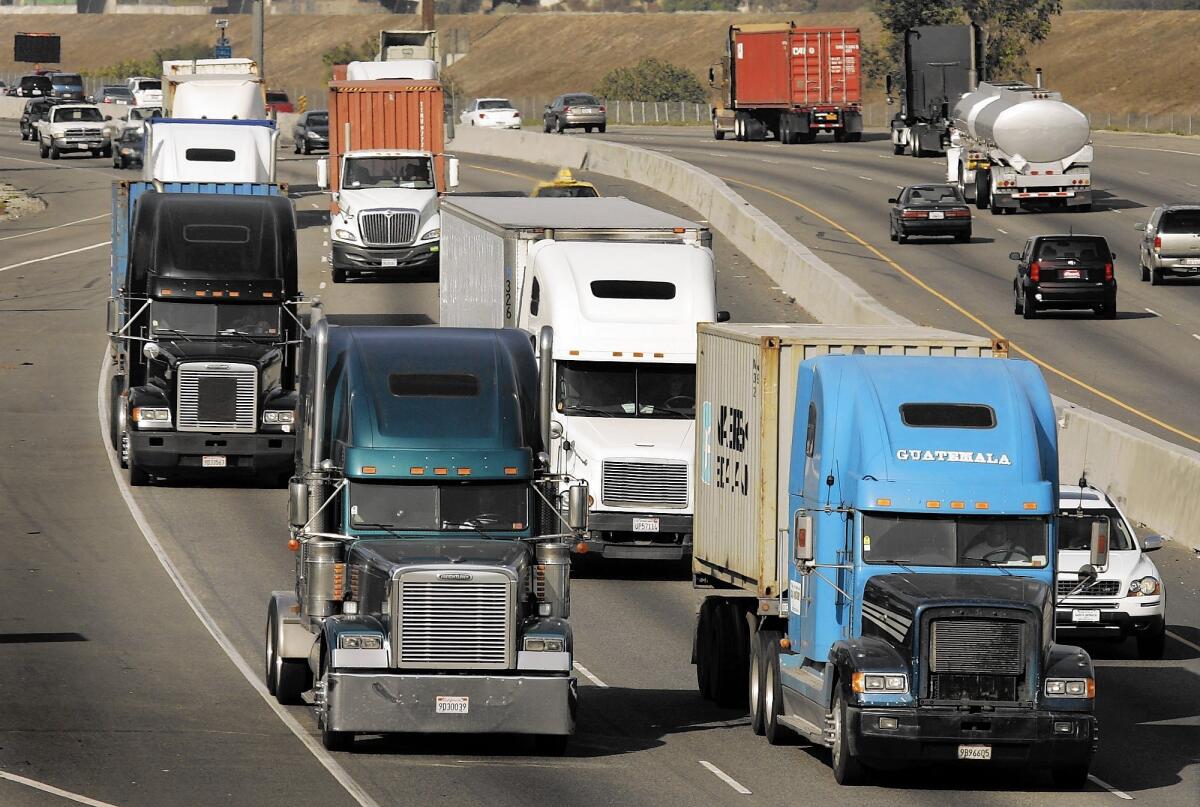 Trucks make their way along the 710 Freeway.