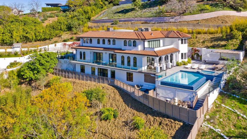 A big white house with a red tile roof