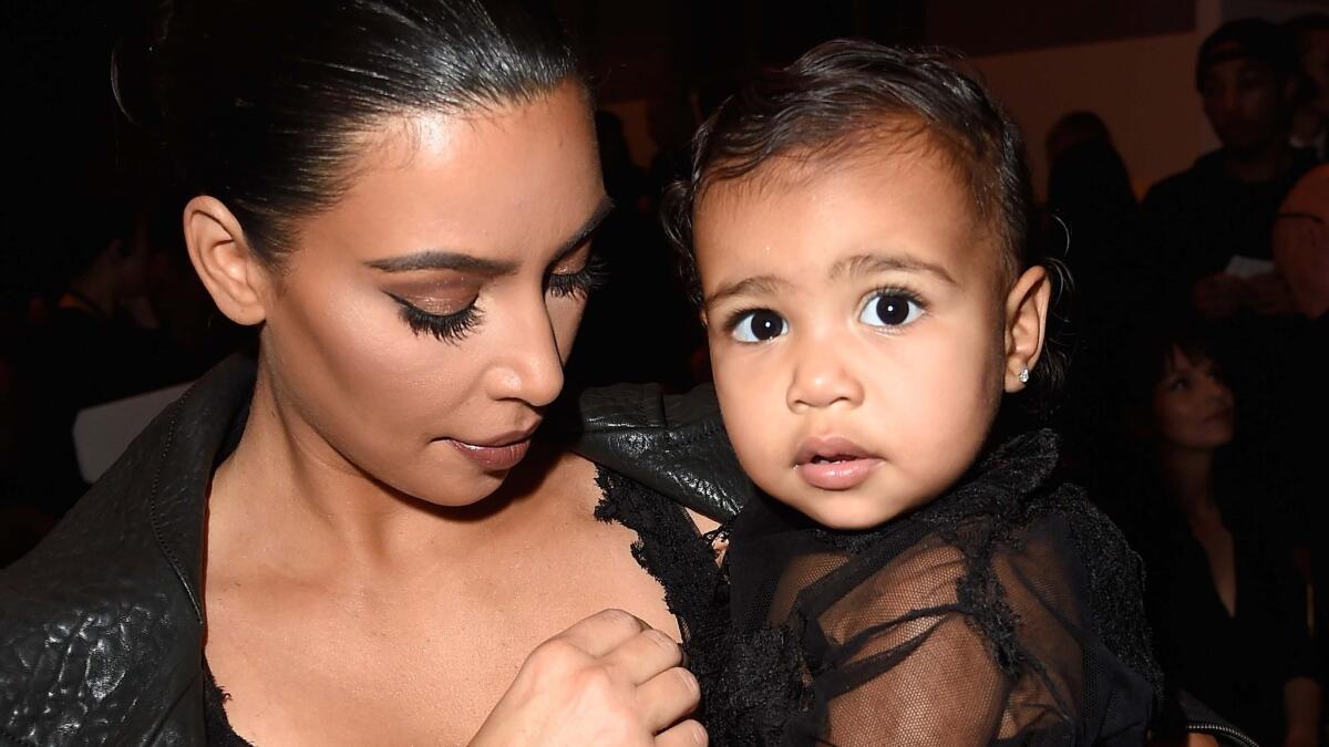 North West looks like she's having way more fun done up like a skunk in Calabasas, below, than she did dressed as a fashionista in Paris with mom Kim Kardashian last month during fashion week, above.