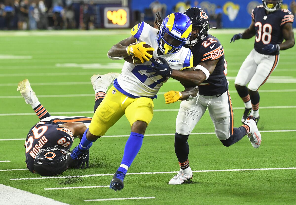 The Rams' Darrell Henderson gets pushed out of bounds by the Bears' Kindle Vildor in the season opener.