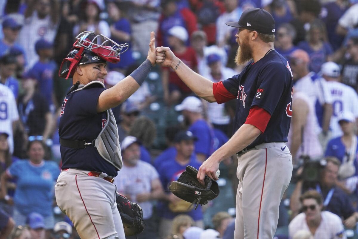 Boston Red Sox catcher Christian Vazquez, left, celebrates with relief pitcher Jake Diekman after they defeated the Chicago Cubs in a baseball game in Chicago, Sunday, July 3, 2022. (AP Photo/Nam Y. Huh)