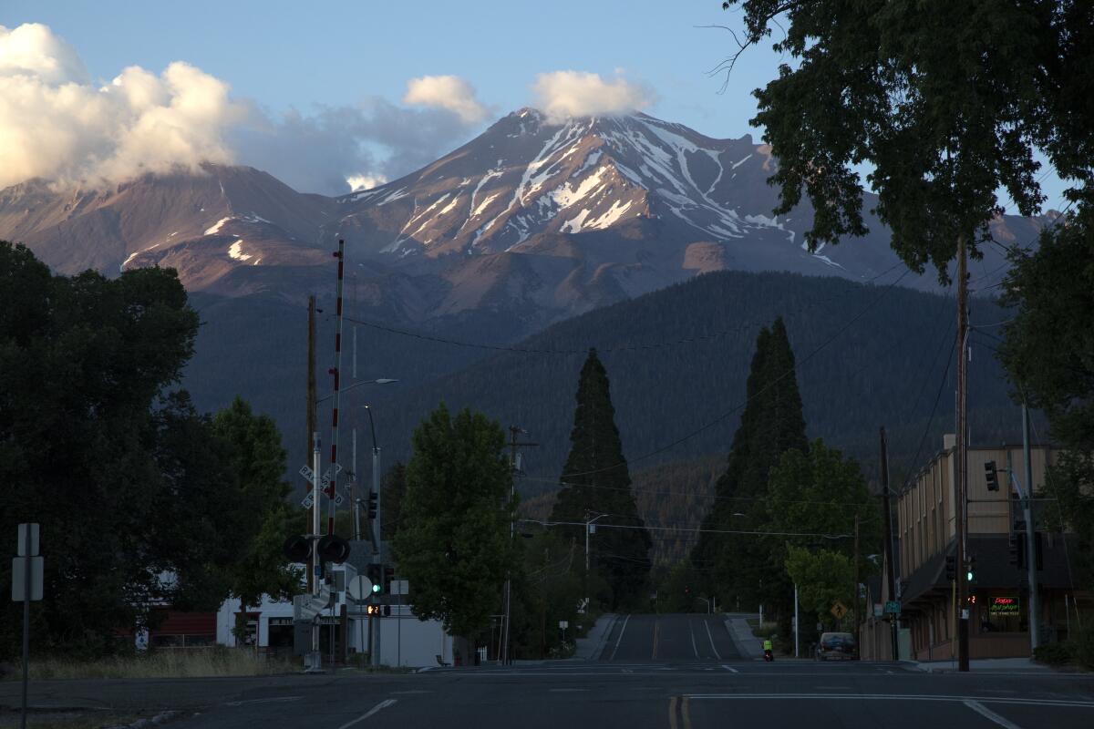 Image of Mt. Shasta, right, and its geologic sibling Shastina, left, as seen from Alma Street in the city of Mt. Shasta.