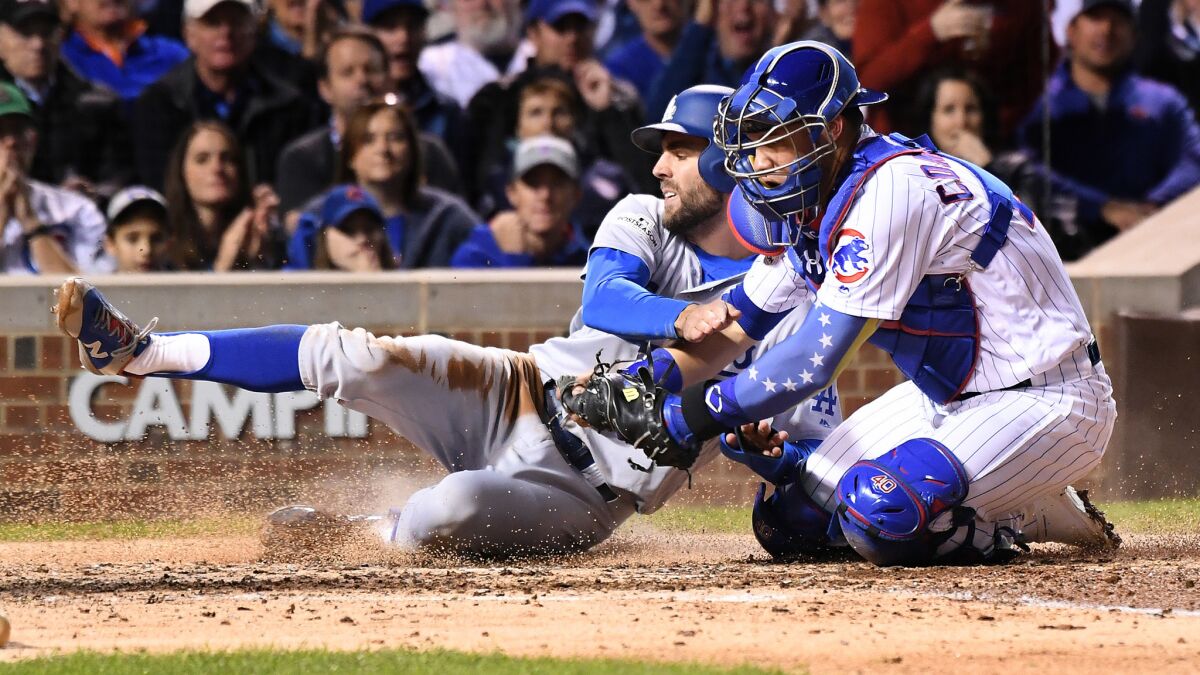 Chris Taylor is tagged out a the plate by Cubs catcher Wilson Contreras.