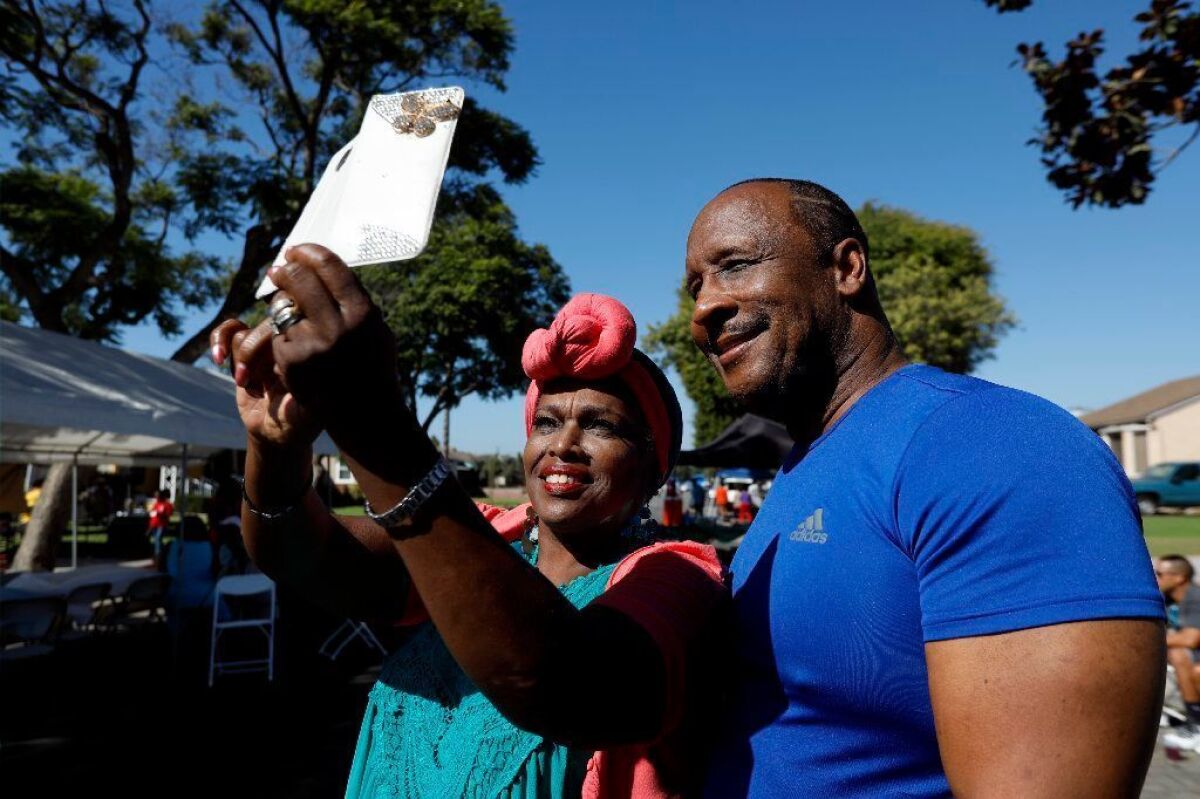 Toni Malone takes a selfie with Inglewood Mayor James T. Butts at a block club party in September.