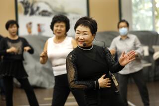 Los Angeles, California-Jan. 27, 2023-At the Koreatown Senior and Community Center about 30 retirees sashayed and shuffled to trot hits lead by Janet Chon, front, on Jan. 27, 2023. (Carolyn Cole / Los Angeles Times)