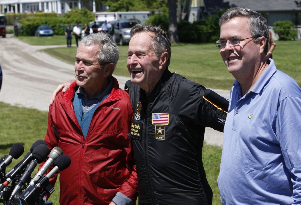 The two George Bushes, at left and center in this 2009 file photo, went unmentioned in Jeb Bush's foreign policy speech Tuesday.