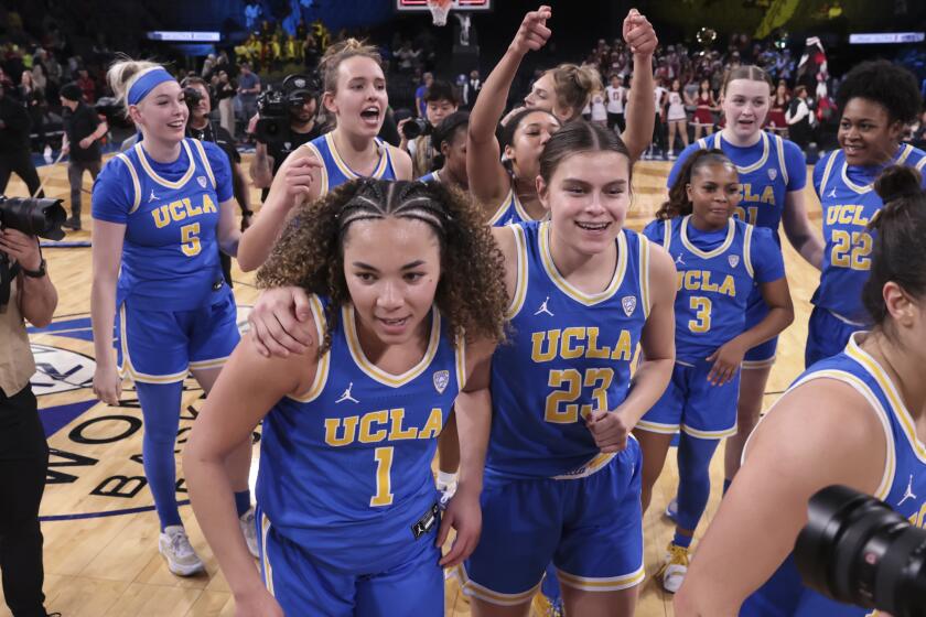 UCLA guard Kiki Rice (1) and forward Gabriela Jaquez (23) head off the court after defeating UCLA.