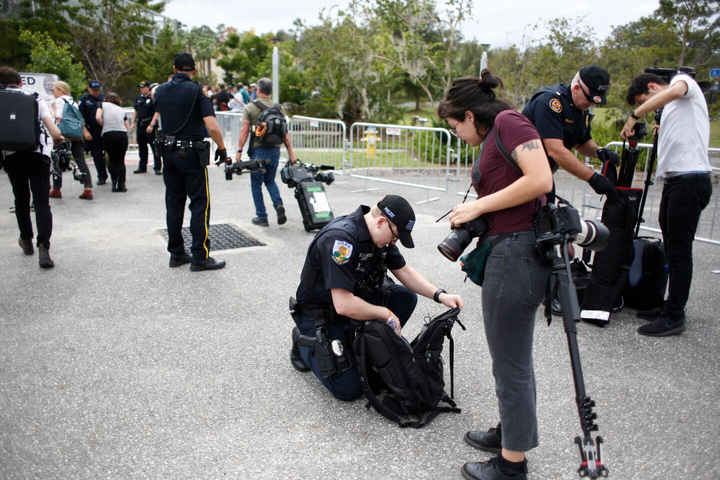 Police check the bags of journalists entering the site of the Richard Spencer event.