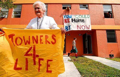 Gloria Adkins demonstrates outside a shuttered Miami public housinf=g complex as homeless advocates take over the building. Activists are holding a weeklong protest before the Super Bowl.