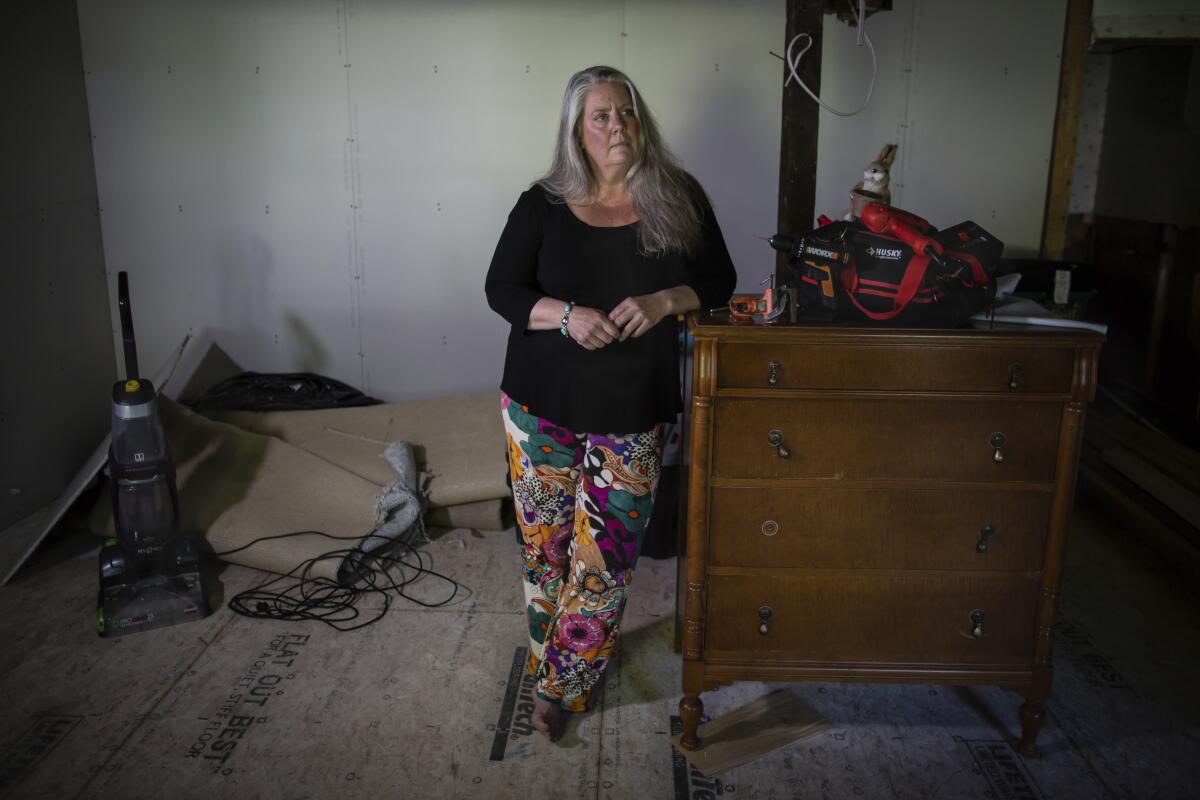 Lisa Edson Neveu in her damaged house in Montpelier, Vt.