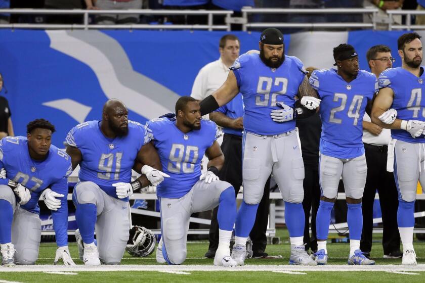 Detroit Lions defensive end Armonty Bryant (97), defensive tackle A'Shawn Robinson (91) and defensive end Cornelius Washington (90) take a knee during the national anthem before an NFL football game against the Atlanta Falcons, Sunday, Sept. 24, 2017, in Detroit. (AP Photo/Duane Burleson)