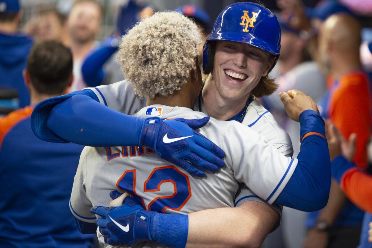 New York Mets' Francisco Lindor, back to camera, celebrates with Brett Baty, who hit a two-run home run against the Atlanta Braves during the second inning of a baseball game Wednesday, Aug. 17, 2022, in Atlanta. (AP Photo/Hakim Wright Sr.)