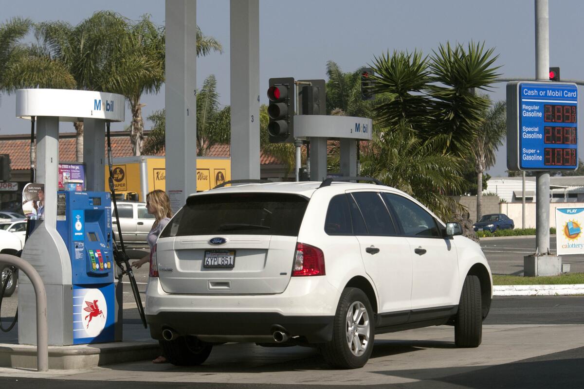 The consumer price index dropped 0.7% in January from December, driven largely by lower gas prices. Above, a station in Huntington Beach.