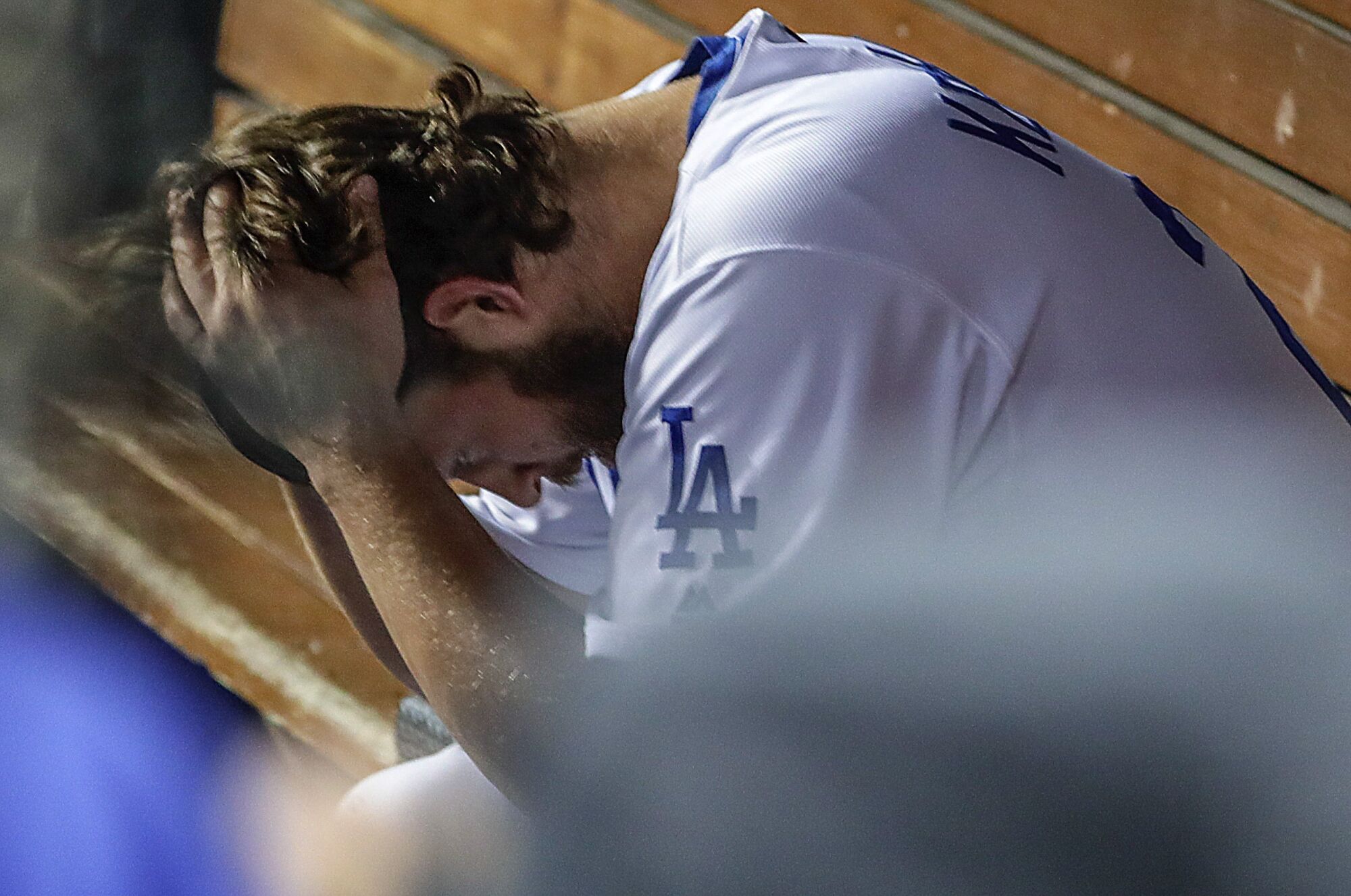 Dodgers pitcher Clayton Kershaw sits in the dugout during the team's loss to the Washington Nationals in the 2019 NLDS.