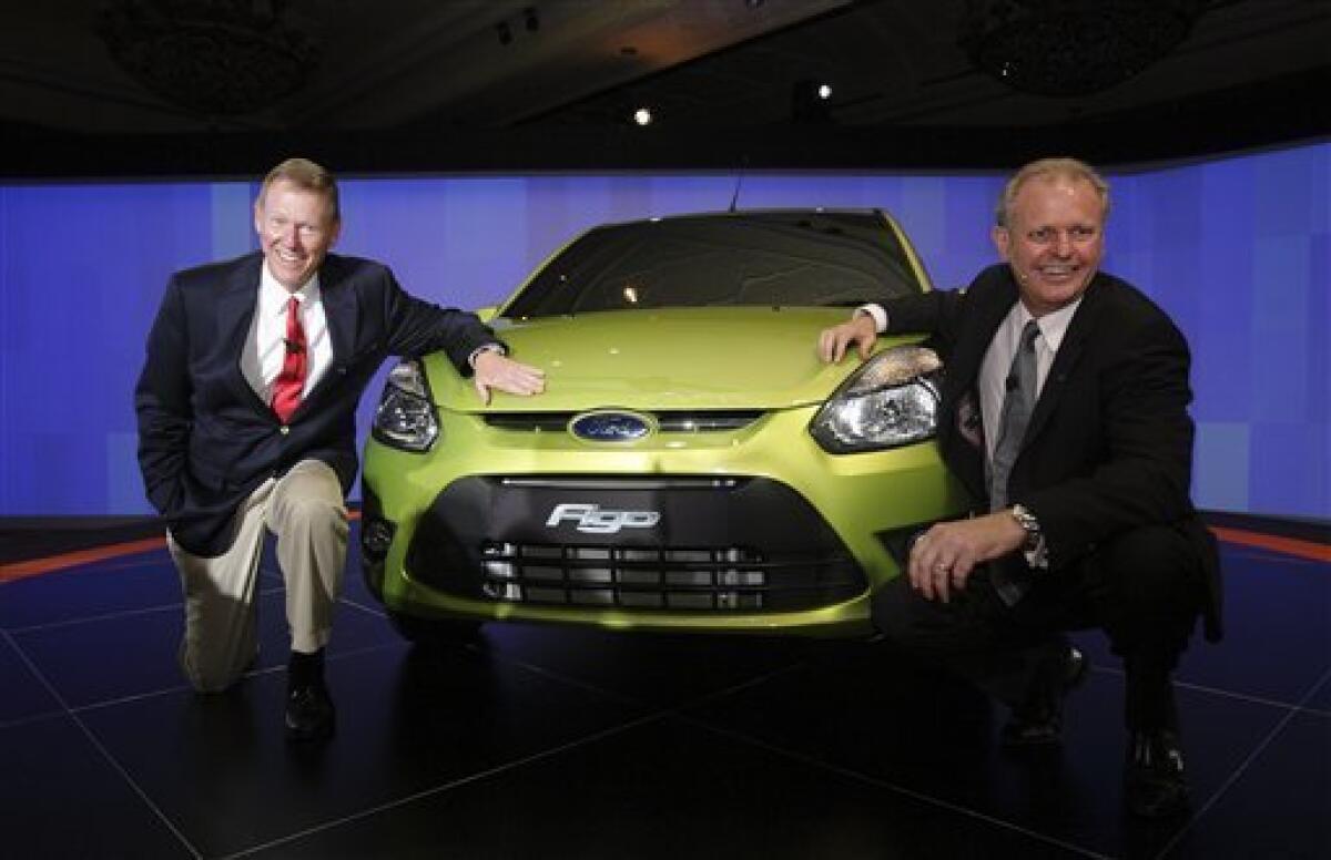 Ford Motor Company President Alan Mulally, left, and Ford India Managing Director Michael Boneham pose for media at the unveiling of Ford Figo in New Delhi, India, Wednesday, Sept. 23, 2009. Ford Motor Co. will manufacture the low-cost compact car in India from early next year, the automaker said Wednesday, as it seeks to boost sales in fast-growing Asia. (AP Photo/Gurinder Osan)