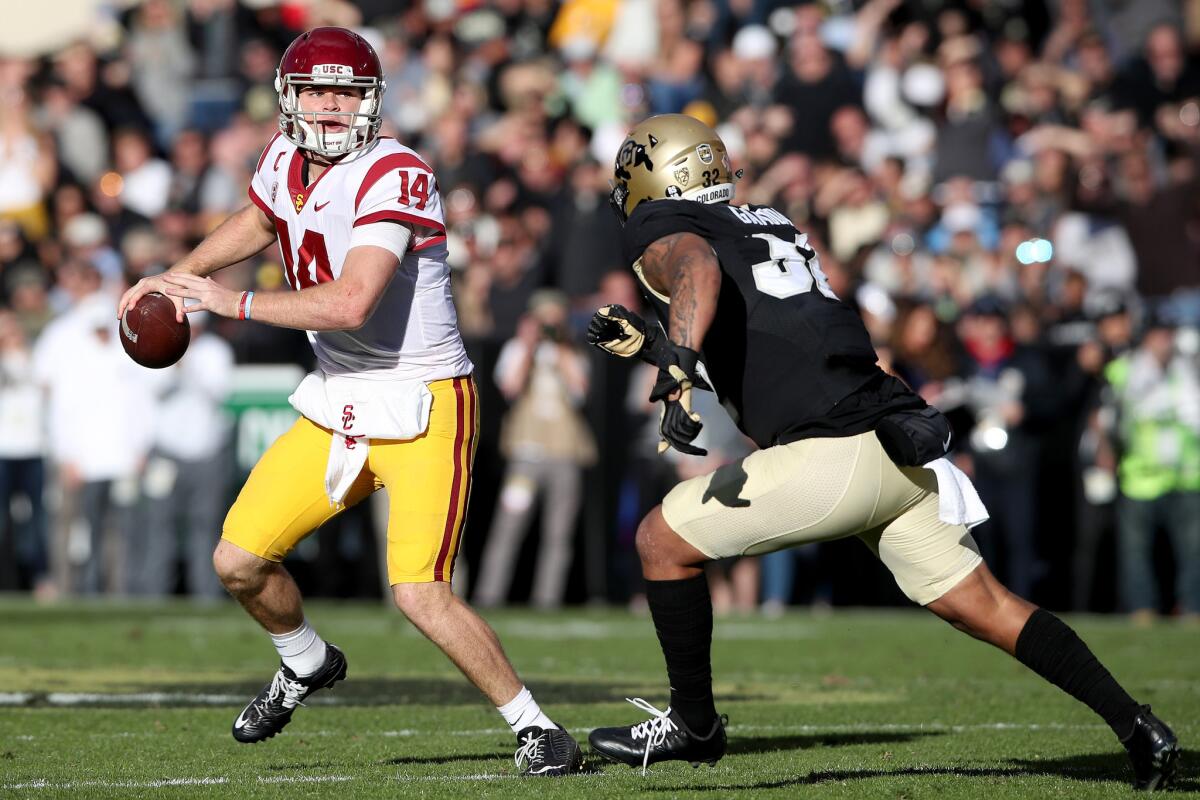 USC quarterback Sam Darnold tries to evade the rush of Colorado's Rick Gamboa during the second half.