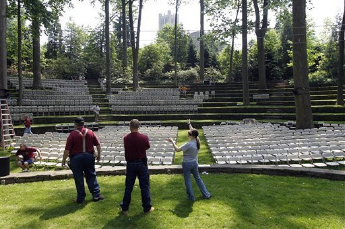 Workers prepare an amphitheater for Swarthmore College's upcoming commencement Thursday, May 26, 2011, in Swarthmore, Pa. The college plans to offer a live, simultaneous translation of its May 29 commencement, where guests will be able to listen to a Spanish version of the ceremony using wireless headsets. (AP Photo/Matt Rourke)
