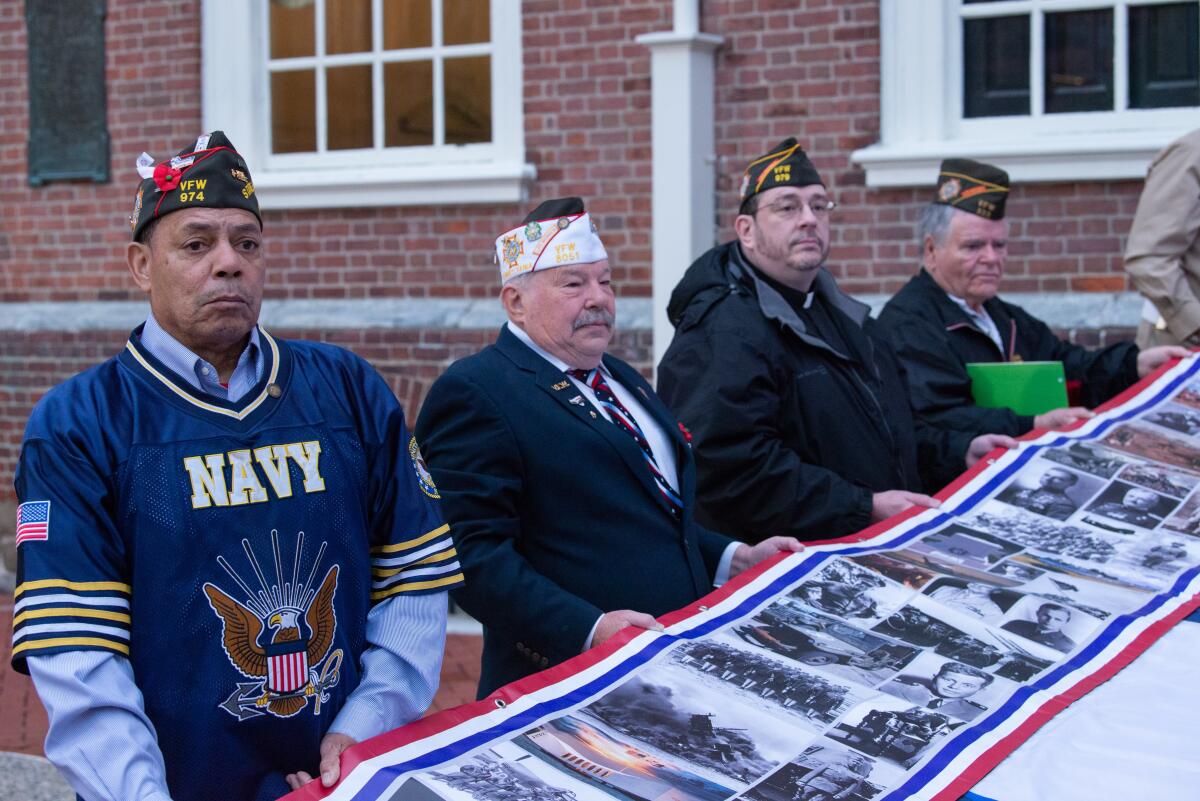 VFW members and veterans unfurling America’s Heroes Flag Art.