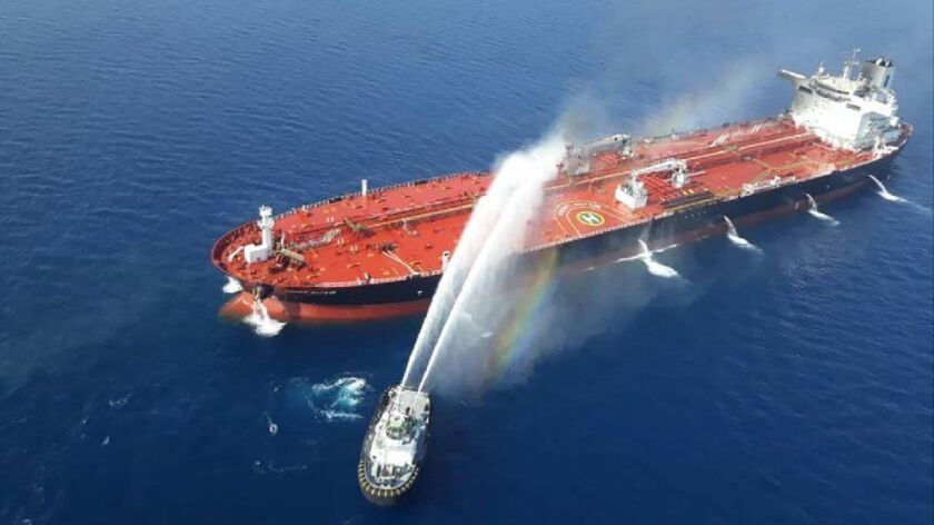 An Iranian navy boat tries to control a fire aboard the Norwegian-owned Front Altair tanker after a reported attack in the Gulf of Oman.