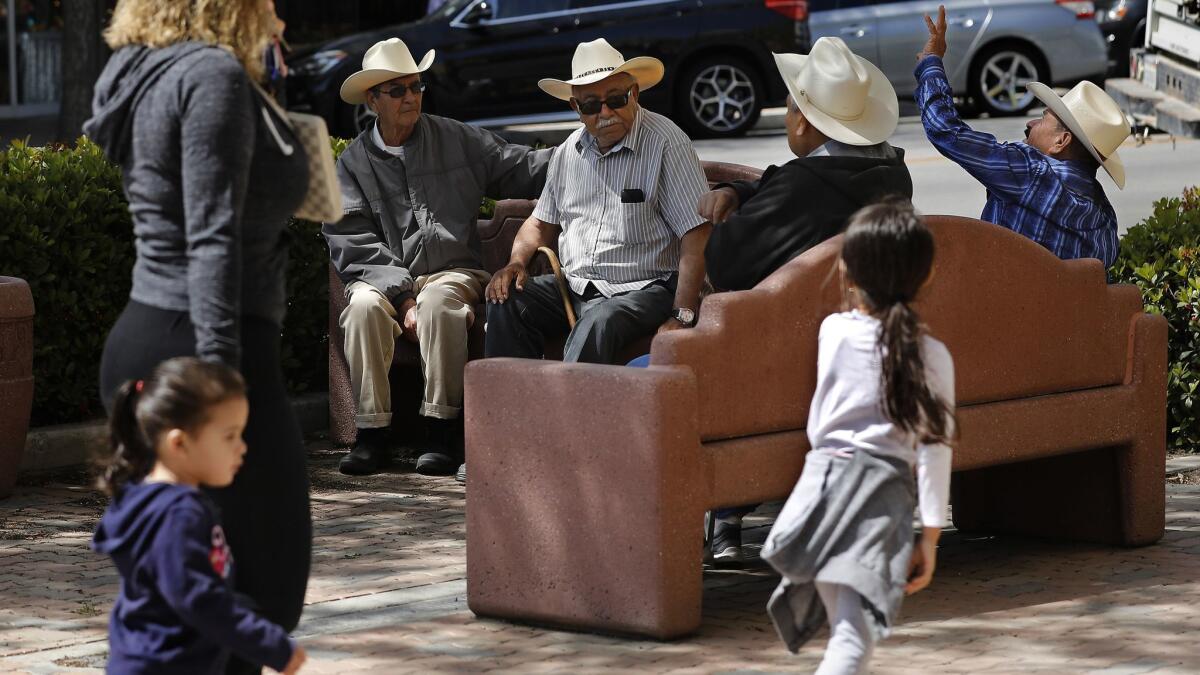 Delano residents gather on Main Street in Delano.