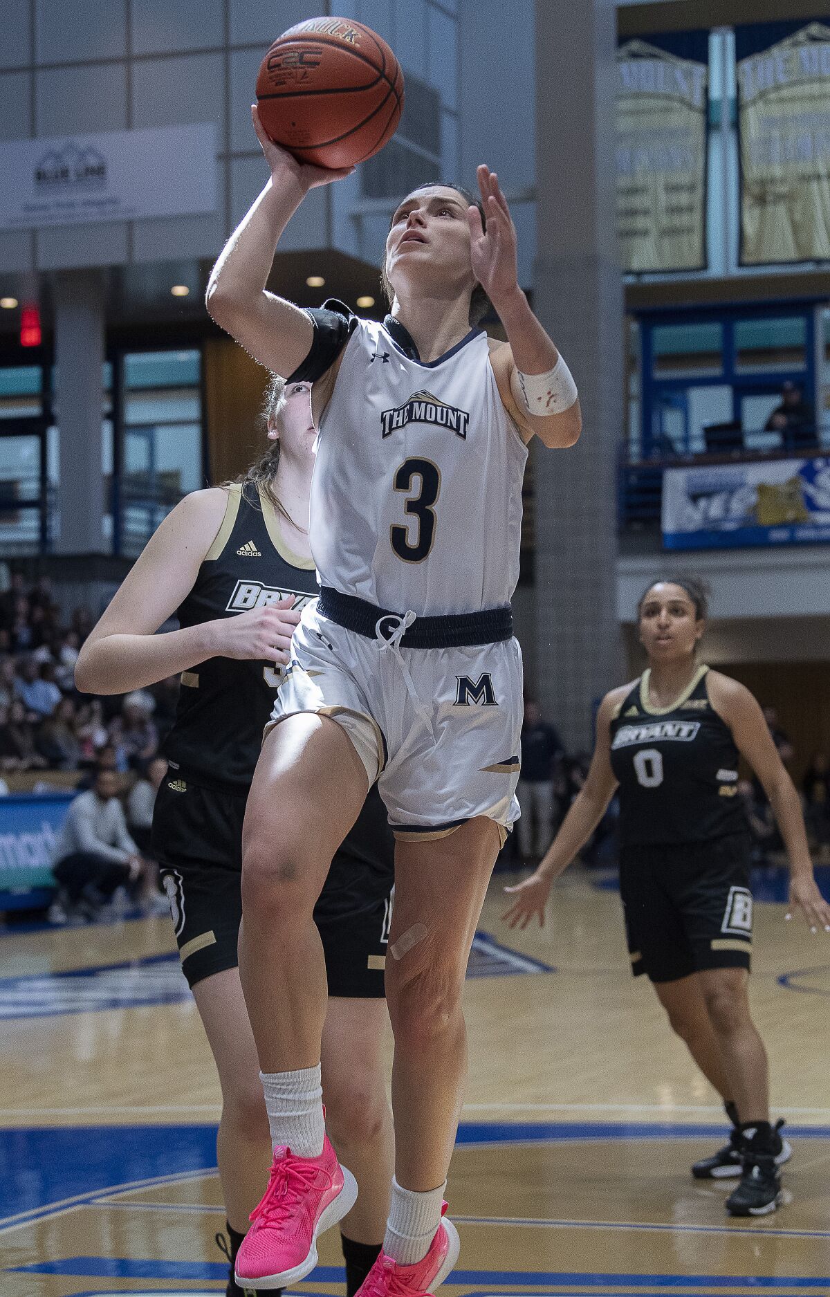 Mount St. Marys' Kendall Bresee (3) gets off a shot past Bryants' defenders in the first half of an NCAA college basketball game for the championship of the Northeast Conference women's tournament, Sunday, March 13, 2021, in Emmitsburg, Md. (Bill Green/The Frederick News-Post via AP)
