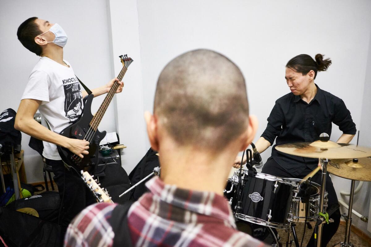 Members of Harikari iz Okna warm up before recording songs in the Youth North recording studio.