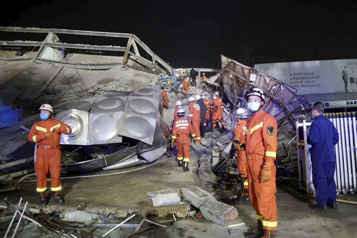 Rescuers work at the site of a collapsed five-story hotel building in Quanzhou city in southeast China's Fujian province Saturday, March 7, 2020. The hotel used for medical observation of people who had contact with coronavirus patients collapsed in southeastern China on Saturday, trapping dozens, state media reported. (Chinatopix Via AP)