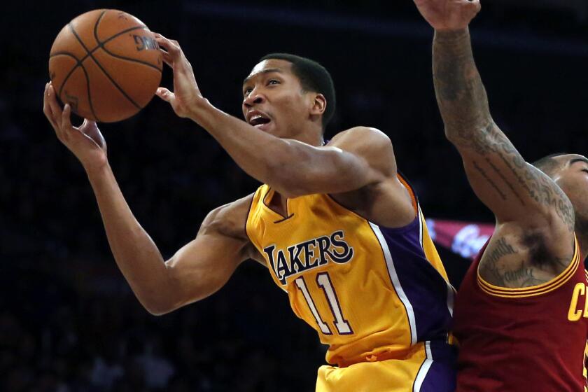 Lakers forward Wesley Johnson, left, grabs a rebound next to Cleveland Cavaliers small forward J.R. Smith during a game at Staples Center on Jan. 15. Johnson is trading one L.A. team for another and has agreed to sign with the Clippers.