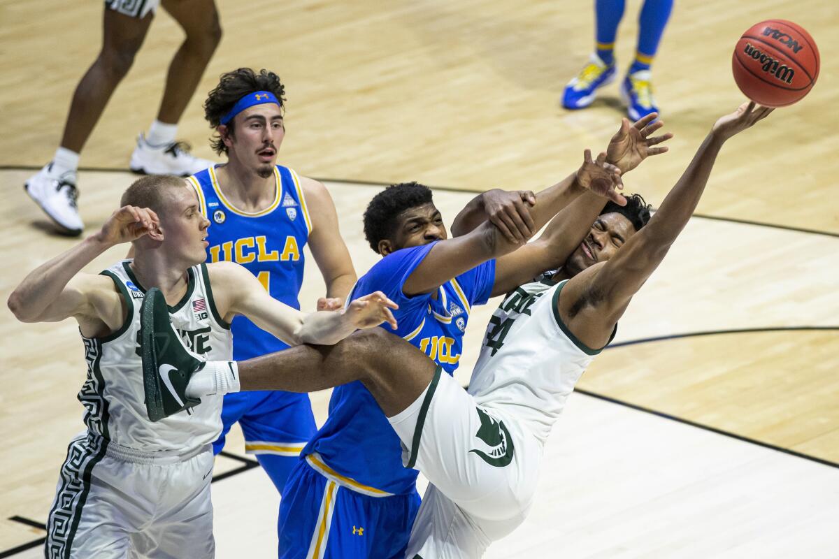Michigan State's Julius Marble II (34) competes for a rebound with UCLA's Cody Riley