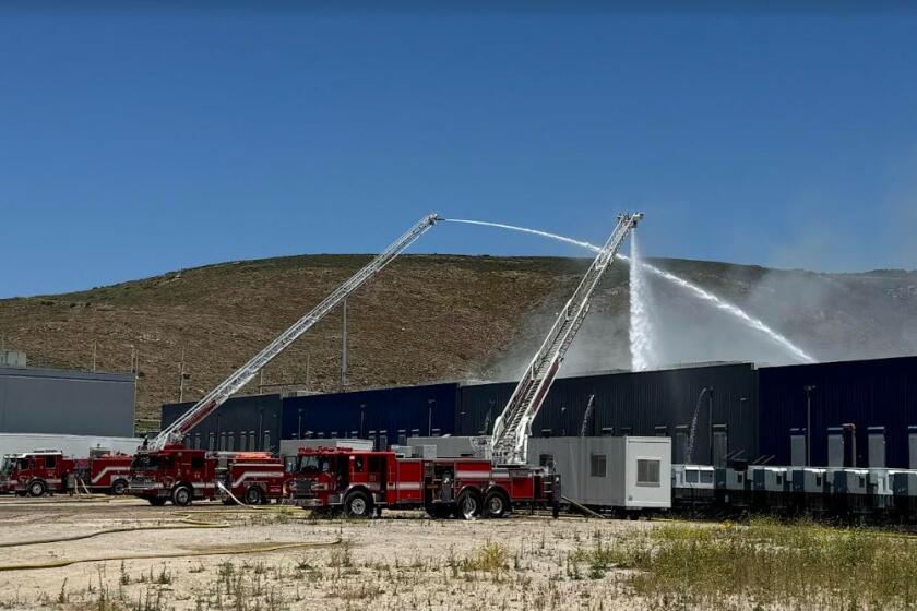 Cal Fire firefighters spray water Saturday on the battery fire at the Gateway Energy Storage Facility in Otay Mesa.  