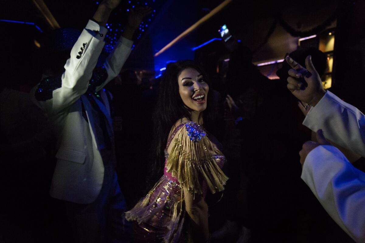 Farah Nasri wears her new Zaki costume during a show at a Cairo nightclub. (Sima Diab / For the Times)