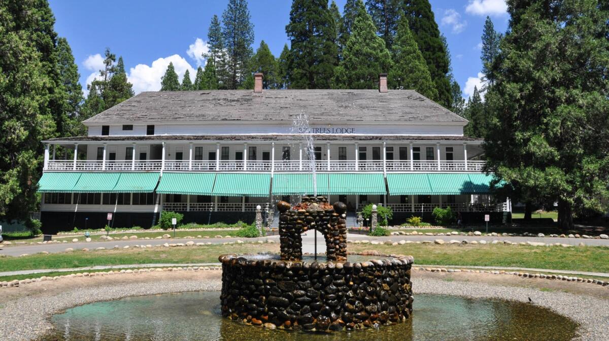 An exterior view of the Wawona Hotel and its fountain in front 