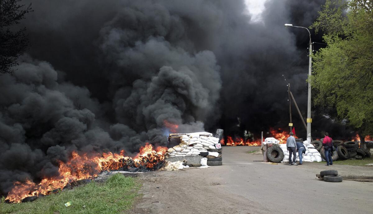 Black smoke billows from barricades outside the Ukrainian town of Slovyansk, set alight by pro-Russia gunmen as they were driven from the site by Ukrainian national forces trying to recover occupied towns and cities in the east of the country.