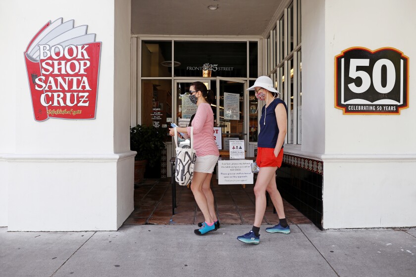Marla Reckart, left, and daughter Sara Cronin pick up books outside Bookshop Santa Cruz.